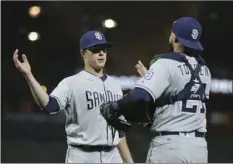  ??  ?? San Diego Padres relief pitcher Phil Maton (left), is greeted by catcher Luis Torrens at the end of their baseball game against the San Francisco Giants Saturday in San Francisco. San Diego won the game 12-9. AP PHOTO/ERIC RISBERG