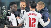  ?? ?? Young guns: Manager Gareth Southgate celebrates with (left to right) Bukayo Saka, Ben Chilwell and Emile Smith Rowe after England clinched their place in the World Cup for a record seventh time in a row