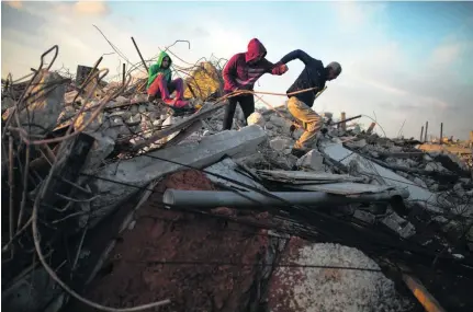  ?? Heidi Levine for The National ?? Youssef Makhlouf with some of his family in the rubble of their homes in the Israeli Arab town Kalansuwa on January 10, where Israeli forces razed 11 illegally built houses in one of the biggest demolition operations in Arab areas in recent years.