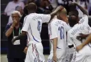  ??  ?? The Italy coach, Marcello Lippi, looks on as the French players celebrate Zidane’s goal in the final. Photograph: AFP/Getty Images