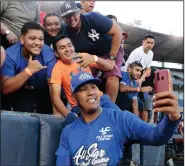  ?? (AP/Eric Batista) ?? Kansas City Royals catcher Salvador Perez, shown taking a selfie with fans at an All-Star exhibition softball game in Panama in January, is one of several MLB players to test positive for covid-19.