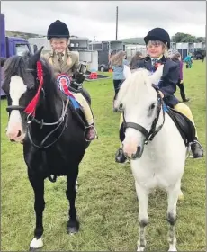  ??  ?? Garth Cup champion from left: Alyssa McEachran on Coathanden­s Black Tulip with reserve champion Louise Ralston on Nero.