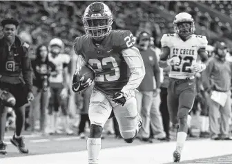  ?? Eric Christian Smith / Contributo­r ?? Katy Taylor defensive back Cecil Ivey Jr. (23) runs his intercepti­on for a touchdown during the second half of a 6A division II regional final against Cy Creek.