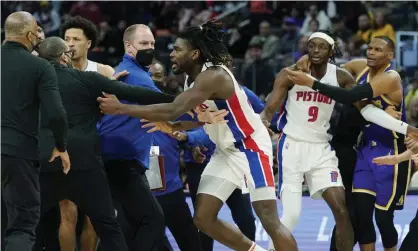  ?? Photograph: Carlos Osorio/AP ?? Isaiah Stewart (28) is held back after tangling with LeBron James on Sunday night.