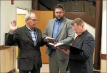  ?? FILE PHOTO ?? Watervliet Councilman Frank McGrouty gets sworn-in by Mayor Michael Manning and city General Manager Jeremy Smith in 2017.