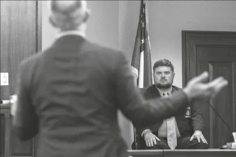  ?? STEPHEN B. MORTON/POOL, AP ?? TRAVIS MCMICHAEL’S ATTORNEY JASON B. SHEFFIELD, CENTER, questions Glynn County Police Department Investigat­ive Detective Parker Marcy, right, during the trial of Greg McMichael and his son, Travis McMichael, and a neighbor, William “Roddie” Bryan in the Glynn County Courthouse, Tuesday in Brunswick, Ga. The three are charged with the February 2020 slaying of 25-year-old Ahmaud Arbery.