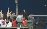  ?? KATHRYN RILEY/GETTY ?? Fans sitting in the left field bleachers in Fenway Park watch the home run ball that Luis Robert hit leave the ballpark in the third inning.