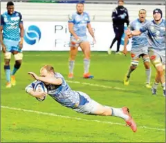  ?? FRED SCHEIBER/AFP ?? Castres’s fly-half Benjamin Urdapillet­a scores a try during the French Top 14 rugby union match between Castres and Montpellie­r on Saturday at Pierre Fabre’s stadium in Castres.