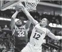  ?? Mark Humphrey / Associated Press ?? Josh Nebo (32) and Texas A&amp;M struggled offensivel­y against Robert Woodard and Mississipp­i State on Thursday night.