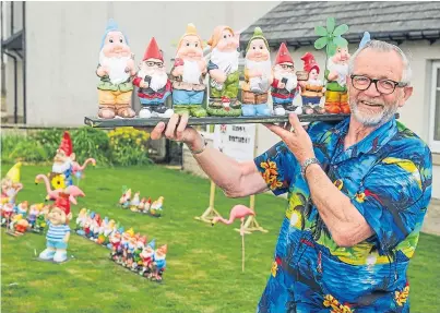  ?? Pictures: Kim Cessford. ?? Gnomes on parade at David McLaren’s garden to help raise money to send the Dunblane Boys’ Brigade to Malawi and, below, the Brigade’s Ross Pringle helps to keep the clan in order.