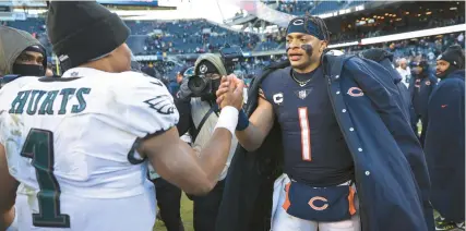  ?? CHRIS SWEDA/CHICAGO TRIBUNE ?? Eagles quarterbac­k Jalen Hurts and Bears quarterbac­k Justin Fields greet each other after an Eagles victory at Soldier Field on Dec. 18.