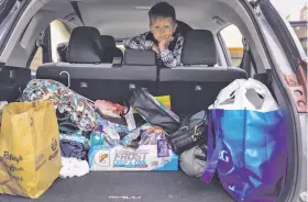  ?? Gabrielle Lurie / The Chronicle ?? After the loss of job and home in the Camp Fire, the family of Landon McDaniel, 5, prepares its few remaining belongings for a move to Oregon.