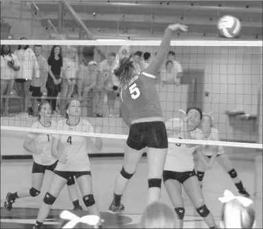  ?? PHOTOS BY MARK HUMPHREY ENTERPRISE-LEADER ?? Top: Anna Dutton pounds a hit for the Farmington volleyball team against a group of Lady Cardinal alumni Friday. Above: Claudia Oxford smashes a hit against Prairie Grove. The rivals met at Cardinal Arena in a pre-season benefit volleyball match won by Farmington Aug. 15.