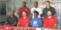  ?? Jeremy Stewart ?? MJ Holiday (seated, second from right) gets photos taken with his basketball and baseball coaches during last Thursday’s ceremony.