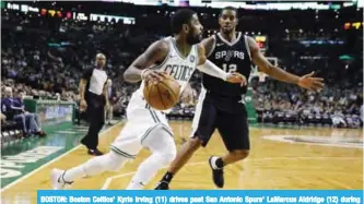  ??  ?? BOSTON: Boston Celtics’ Kyrie Irving (11) drives past San Antonio Spurs’ LaMarcus Aldridge (12) during the third quarter of an NBA basketball game in Boston, Monday.