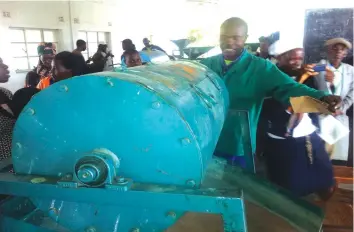  ??  ?? Zaka Super Seeds Associatio­n employees demonstrat­e how seeds are graded at the warehouse at Fuve-Panganai Irrigation Scheme recently