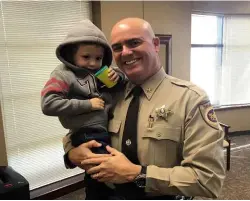  ??  ?? ABOVE LEFT: Three-year-old Casey Hathaway visits the Craven County Sheriff’s Office following his rescue after two nights alone in the freezing cold forest.
ABOVE RIGHT: Black bears are a common sight in North Carolina, but could one really have looked after Casey while he was lost in the woods as the boy claimed?