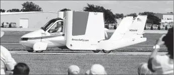  ?? Joe Sienkiewic­z Associated Press ?? TERRAFUGIA’S gasoline-powered plane can fold its wings and meet legal requiremen­ts for highway driving. The company hopes to deliver a version to customers in 2017, at an expected price of $279,000.