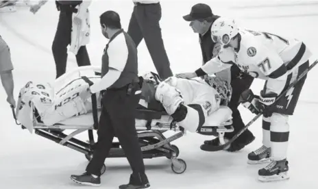  ?? CHARLES LECLAIRE/USA TODAY SPORTS ?? Lightning goalie Ben Bishop is stretchere­d off the ice after injuring his knee during play against the Penguins on Friday in Game 1 of the Eastern final.