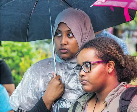  ?? PHOTOS: WAYNE CUDDINGTON ?? Fadumo Aden and Hodsn Omar listen to speeches at a community gathering and announceme­nt in Somerset Square Park by the Justice for Abdirahman Coalition, held Tuesday on the second anniversar­y of Abdirahman Abdi’s death during an altercatio­n with police.