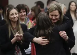  ?? CARLOS OSORIO — THE ASSOCIATED PRESS FILE ?? In this Jan. 24, 2018, file photo, victims react and hug Assistant Attorney General Angela Povilaitis after Larry Nassar was sentenced to 40to 175years in prison during a sentencing hearing in Lansing, Mich.