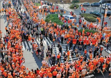  ?? Associated Press ?? SEC returns: In this Oct. 5, 2019, file photo, Tennessee players and coaches take part in the Vol Walk at Neyland Stadium before the team's NCAA college football game against Georgia in Knoxville, Tenn. Pre-game traditions are making a return this season, like Tennessee's pre-game Vol Walk, minus the high-fives or any other physical contact with players. No masks will be required--just encouraged--inside Neyland Stadium, the nation's fifth-largest stadium. Tennessee faces Bowling Green in their season opener tonight.