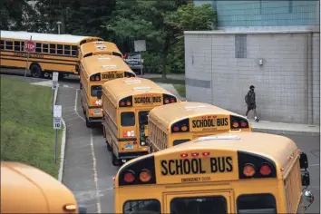  ?? John Moore / Getty Images ?? Buses depart after dropping off students at Rippowam Middle School in Stamford on Sept. 14, 2020.