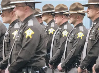  ?? MICHAEL GARD/POST-TRIBUNE PHOTOS ?? Officers stand at attention during the annual Porter County Sheriff’s Office Police Memorial on Wednesday at Ivy Tech Community College in Valparaiso.