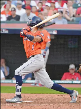  ?? Associated Press ?? Going yard: Houston Astros shortstop Carlos Correa hits a three-run home run in the eighth inning during Game 3 of the American League Division Series against the Cleveland Indians Monday in Cleveland.