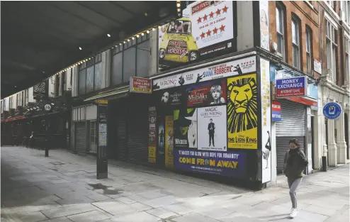  ??  ?? A pedestrian walks through the near- empty West End district in London. With continuing restrictio­ns on social gatherings due to the COVID-19 pandemic, there’s no prospect of live theatre opening again soon.