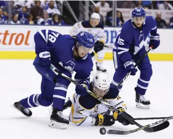  ??  ?? The Toronto Maple Leafs need immediate help on the blue-line, but columnist Michael Traikos recommends they keep an eye to the future and resist trading top prospect Rasmus Sandin, left.