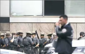  ?? Michael Noble/Associated Press ?? Police gather Friday outside Bronx-Lebanon Hospital in New York after a doctor opened fire there, killing one and wounding six, before killing himself. Story,