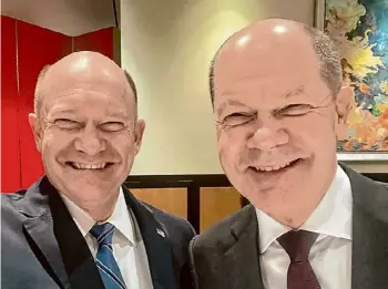  ?? U.S. Sen. Chris Coons via Associated Press ?? U.S. Sen. Chris Coons, D-Del., left, and German Chancellor Olaf Scholz were seeing double when they met in Washington and went on social media to share their mirror image with the world.