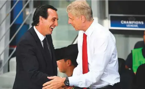  ?? AFP ?? Paris Saint-Germain coach Unai Emery shakes hands with Arsenal’s French manager Arsene Wenger during a Uefa Champions League Group match in Paris. The Spaniard is Arsenal’s first new manager in 22 years.