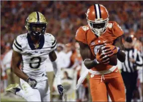  ?? RAINIER EHRHARDT — THE ASSOCIATED PRESS FILE ?? FILE- In this file photo, Clemson wide receiver Deon Cain (8) makes a catch as Pittsburgh defensive back Damar Hamlin (3) defends during the second half of an NCAA college football game in Clemson, S.C. Deon Cain knows the questions are coming and he...