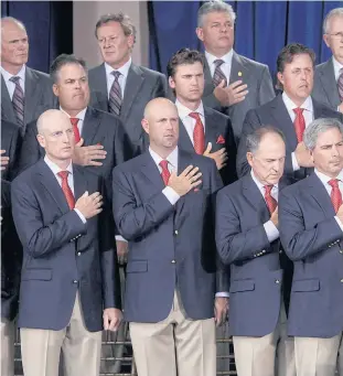  ??  ?? Bush, standing behind the trophy, and members of the US team during the opening ceremony of the 2009 Presidents Cup.