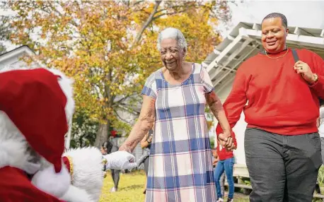  ?? Photos by Annie Mulligan/Contributo­r ?? Dorothy “Big Mama” Kirkpatric­k, 95, asks Santa for a husband after watching her great-great-great grandson Zion visit the jolly elf.