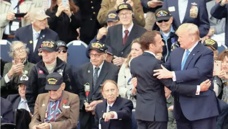  ?? | Reuters ?? US PRESIDENT Donald Trump and French President Emmanuel Macron with World War II veterans during a ceremony to mark the 75th anniversar­y of the D-Day at the Normandy American Cemetery and Memorial in Colleville-sur-Mer, France, yesterday.