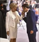 ?? (Photo Max PPP) ?? Le Président réélu faisant le baise-main à son épouse Brigitte.