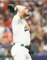  ?? Photos by Tony Dejak / Associated Press ?? A’s pitcher Liam Hendriks gave up a solo homer but struck out three in his inning.