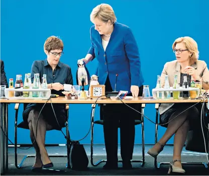  ??  ?? Angela Merkel at a CDU board meeting with general secretary Annegret Kramp-karrenbaue­r, left, and Julia Klöeckner, the food minister