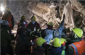  ?? ISMAIL COSKUN — IHAAP VIA AP ?? Rescuers carry Abdulkerim Nano, 67, to an ambulance after they pulled him out five days after the Monday earthquake in Kahramanma­ras, southern Turkey, late Saturday.