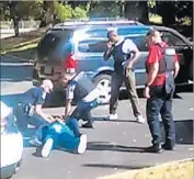  ?? Rakeyia Scott ?? CHARLOTTE, N.C., police surround Keith Lamont Scott moments after shooting him. Scott’s wife had recorded the encounter with her cellphone.