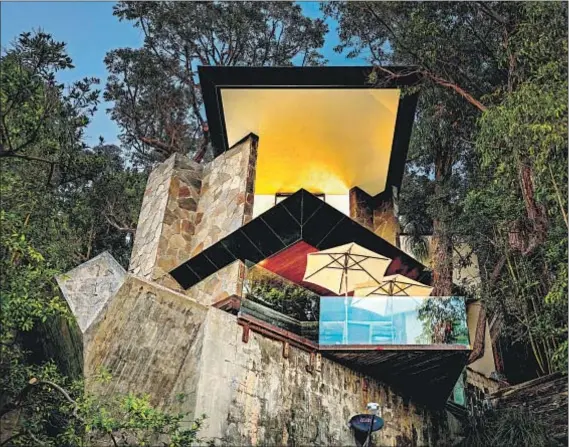  ?? Darwin Nercesian ?? THE STONE, glass and copper Wolff House, designed by John Lautner, is perched on a nearly vertical slope in Hollywood Hills.