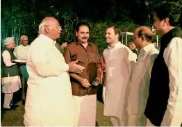  ?? — PTI ?? Congress president Rahul Gandhi interacts with Congress leader Mallikarju­n Kharge and other Opposition party leaders before the dinner hosted by UPA chairperso­n Sonia Gandhi at her residence, 10, Janpath, in New Delhi on Tuesday.