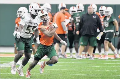  ?? MICHAEL LAUGHLIN/SUN-SENTINEL ?? UM receiver Mark Pope, with ball, makes his move during a 2019 practice. “He has such a tremendous skill set. It should translate to him being a really good player because he has just great quickness,” says Miami wide receivers coach Rob Likens.