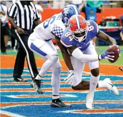  ?? Associated Press ?? ■ Florida tight end Kyle Pitts (84) catches a pass in front of Kentucky defensive back Brandin Echols for a 2-yard touchdown on a pass play during the second half of an NCAA football game Nov. 28 in Gainesvill­e, Fla. No. 6 Florida doesn’t really even try to run the ball anymore. There’s an occasional handoff here and there, but the Gators are mostly one-dimensiona­l — and that’s fine with coach Dan Mullen, Heisman Trophy front-runner Kyle Trask and arguably the deepest receiving corps in the country.