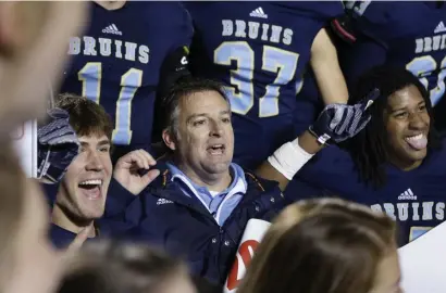  ?? AP FILe ?? ‘GREAT SUCCESS’: Pulaski Academy coach Kevin Kelley (center) celebrates with his team after winning the Arkansas Class 5A High School Championsh­ip on Dec. 6, 2014.