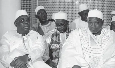  ?? Senegalese President’s Office ?? NEWLY ELECTED Gambian President Adama Barrow, right, attends Friday prayer in Dakar, Senegal, with President Macky Sall, left. Barrow was sworn into office at the Gambian embassy in Senegal as outgoing President Yahya Jammeh yielded to pressure to leave office.