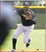  ?? Chris O’Meara / Associated Press ?? New York Yankees’ Didi Gregorius fields a ground ball during a Gulf Coast League game on Monday in Tampa, Fla. Gregorius is playing for the first time since having Tommy John surgery.